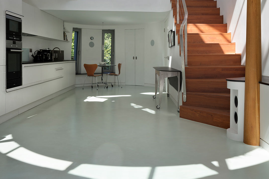 Poured resin floor in Highgate: seamless RAL 7035 kitchen floor and timber stair at 6 Wood Lane